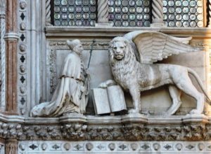 Venice - the Doge's Palace - the Dogs with the lion of St Mark above the portico that connects the palace to the basilica and leads to the entrance of the palace