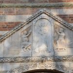 Pavia, Basilica di San Pietro Cielo d’Oro - above the front entry door - Saint Michael the Archangel and two saints